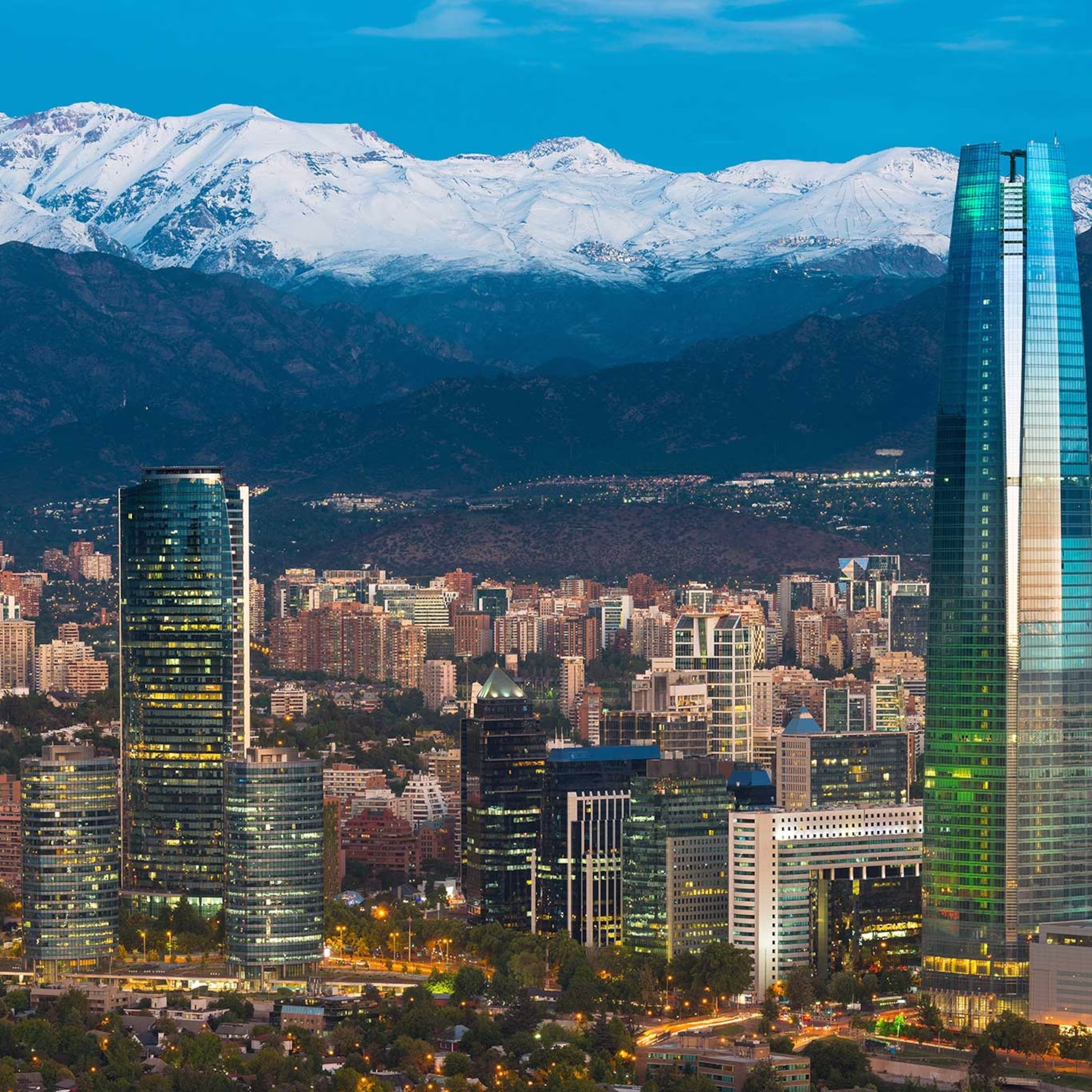 The panoramic view of Santiago, Chile, showcasing the Andes mountains backdrop and the city's modern educational facilities.