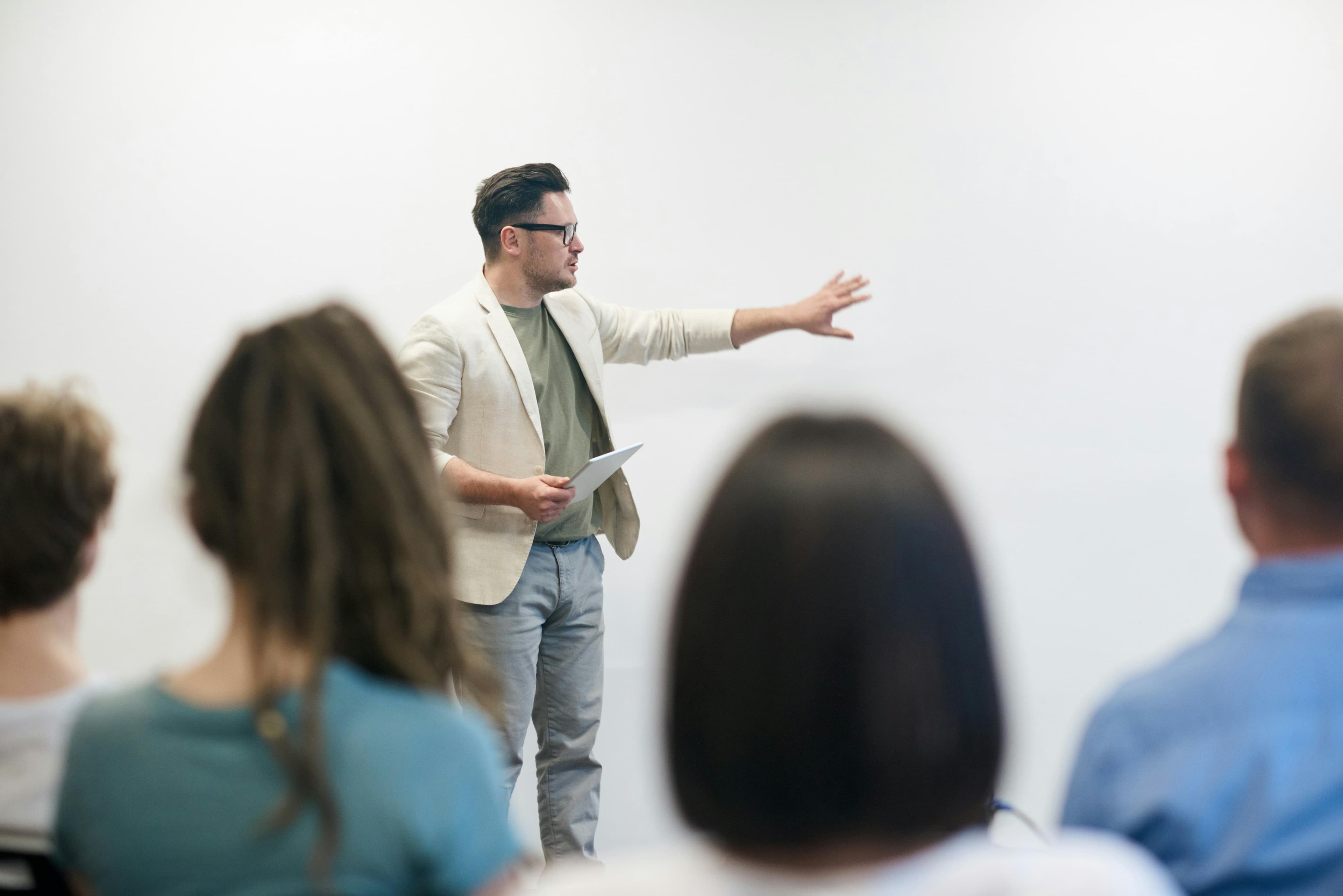 A university lecturer delivering lectures and teaching students in seminars related to their field, with primary responsibilities outlined
