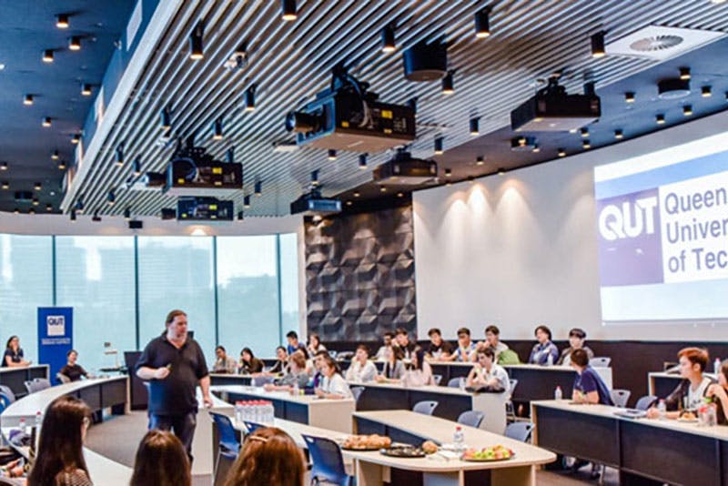 lecturer educating students at qut (queensland university of technology)