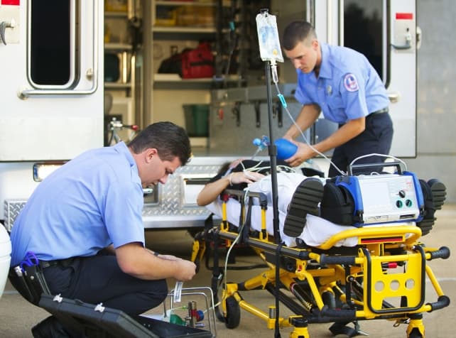 Paramedics and EMTs rushing to help a patient