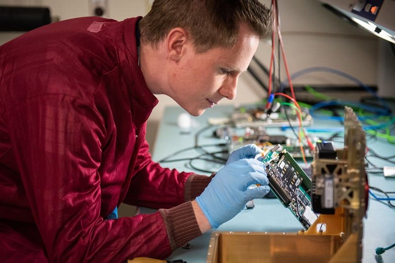 An image capturing the essence of Electronics, showcasing an engineer working on an intricate electronic device, symbolizing the meticulous and innovative nature of the field