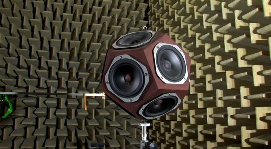 An acoustic engineer adjusting advanced audio equipment in a sound testing lab, showcasing the precision and expertise in the field