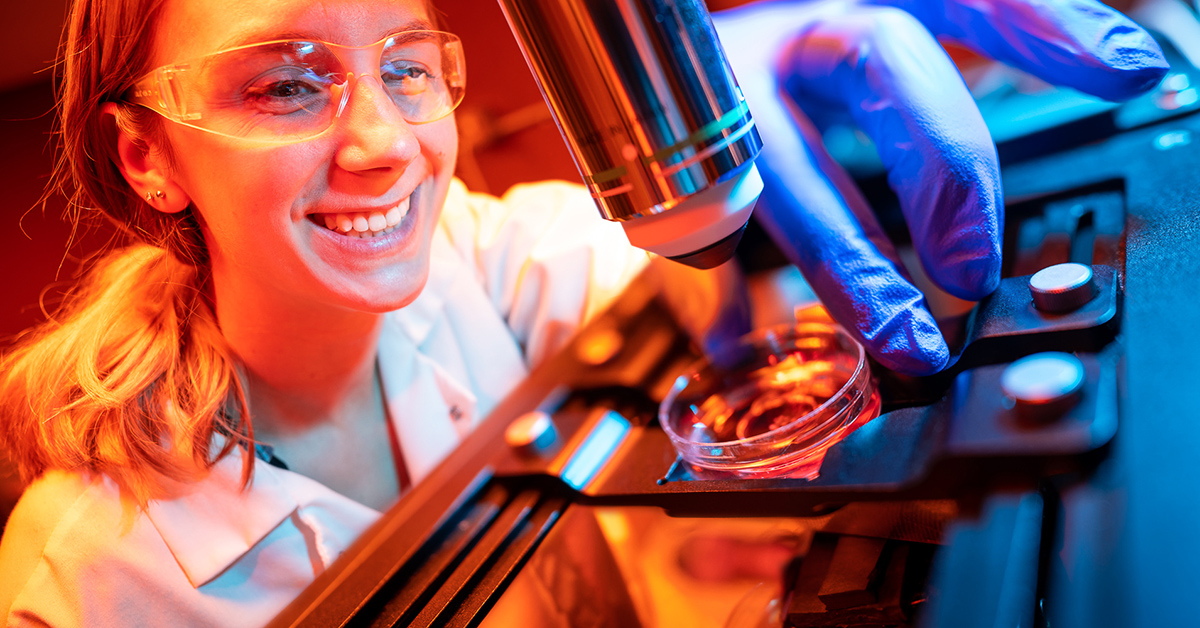 An engaging image showing a materials engineer examining a newly developed material under a microscope, highlighting the innovative and detailed nature of the field